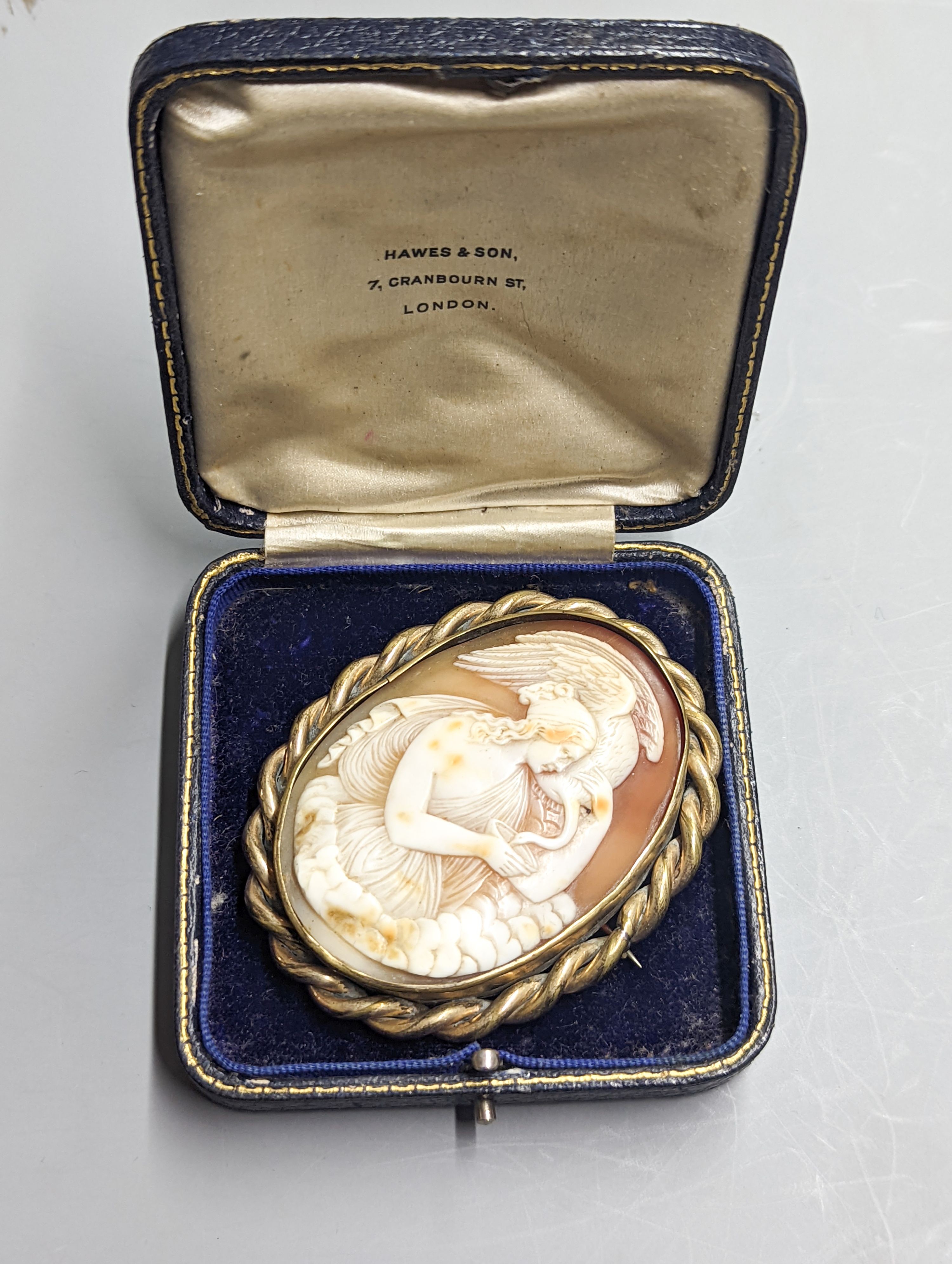A late Victorian gilt metal mounted oval cameo shell brooch, carved with Leda & the Swan, 72mm.